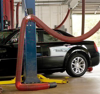 Source-capture overhead exhaust removal system with hose drops installed in multi-bay vehicle service shop.