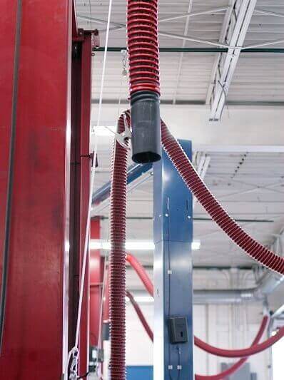 Fume-A-Vent overhead vehicle exhaust removal system installed to capture and exhaust emissions away from the work environment.